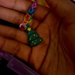 Christmas bracelet with a tree and it says Xmas